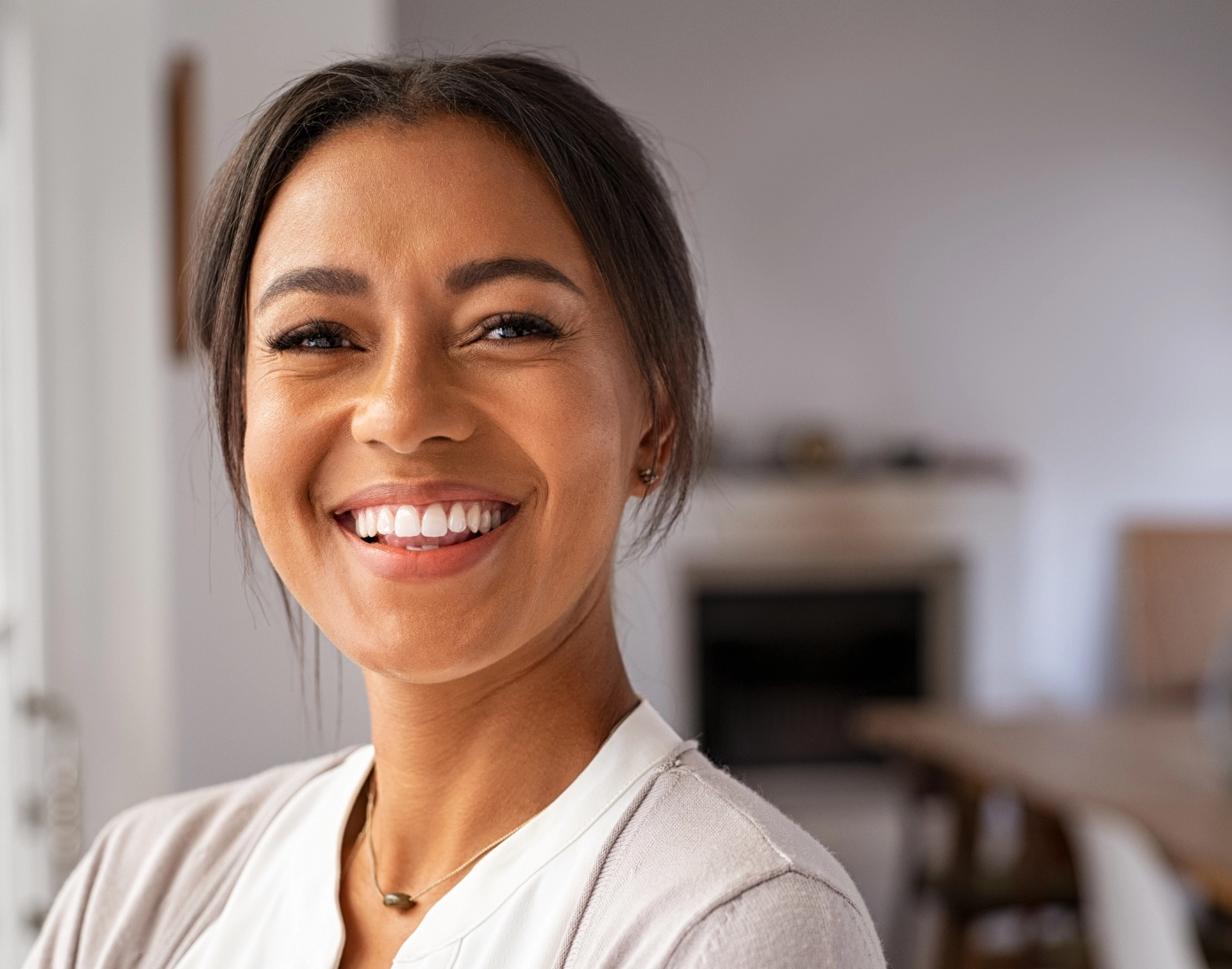 A young woman smiles after receiving Botox.