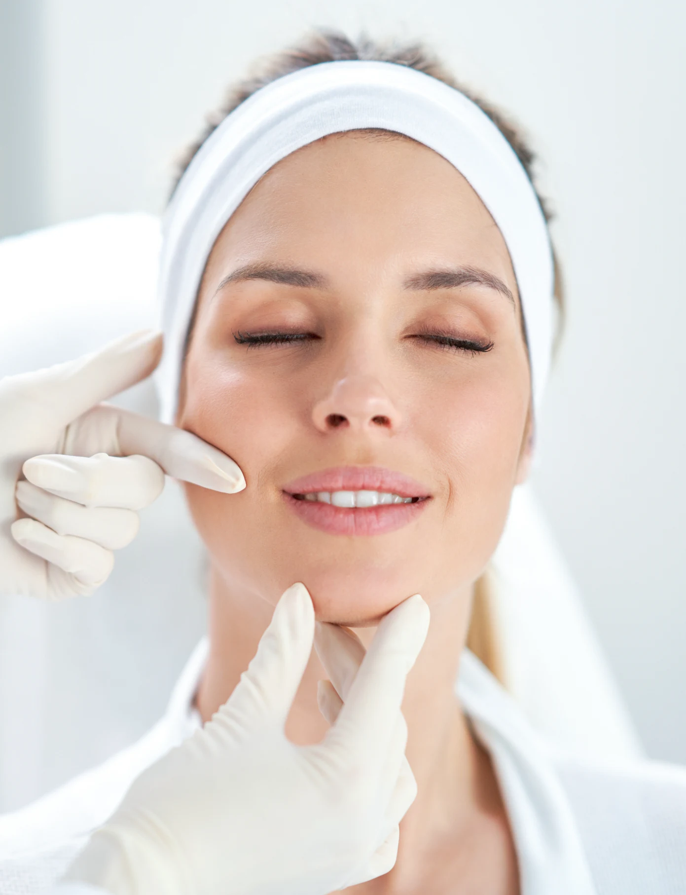 A young woman is relaxed during a Botox consultation.